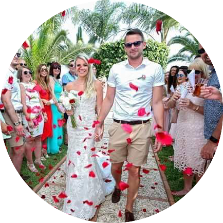 Family throwing petals to couple